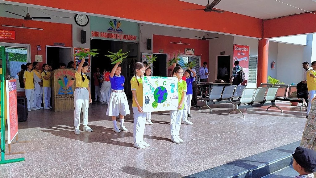 SRJ Academy Earth Day group with Earth poster