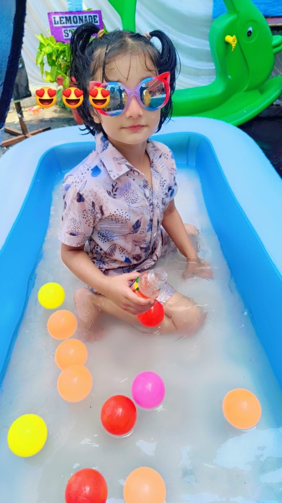 Child enjoying inflatable pool at SRJ Academy